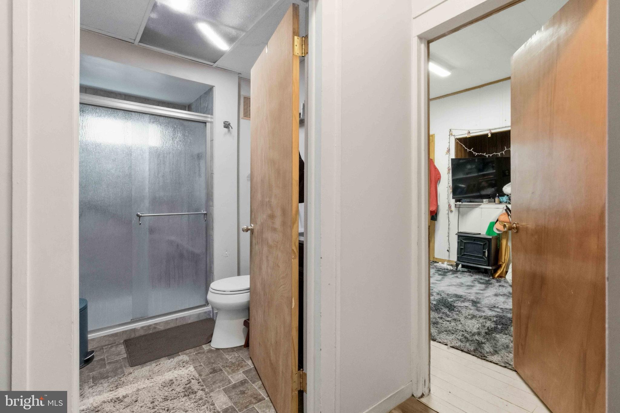 38 State Road Barnesville, PA 18214 - Photo 17 of 46 a bathroom with a granite countertop shower a toilet and a sink
