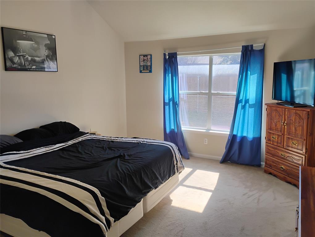 11705 Netleaf Lane Fort Worth, TX 76244 - Photo 4 of 20 a bedroom with a bed and a window