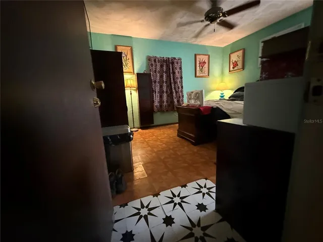 a bedroom with bed and a flat screen tv