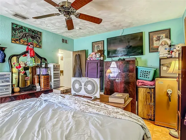 a bedroom with a bed and dresser with mirror