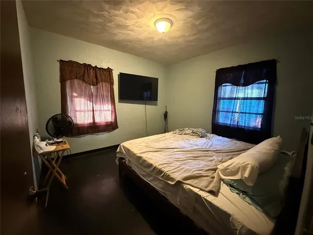 a bedroom with a bed and window