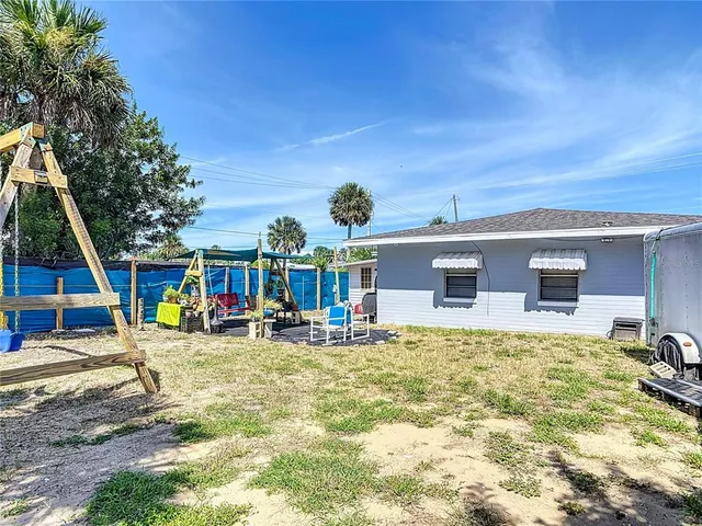 a view of a backyard with a table and chairs