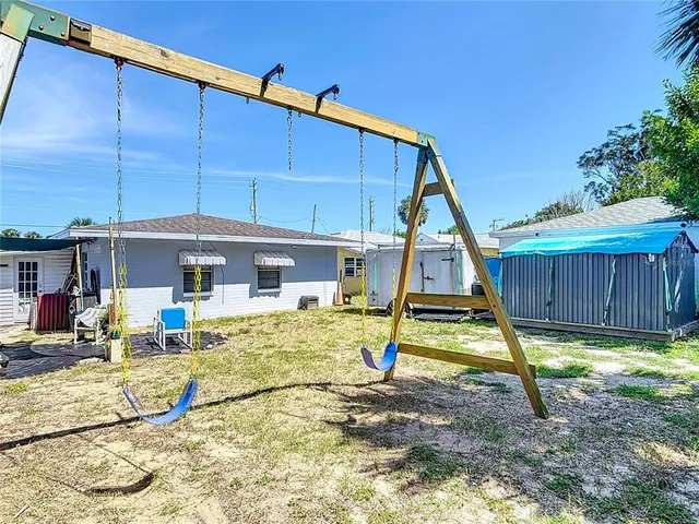 an aerial view of a house with garden space and street view