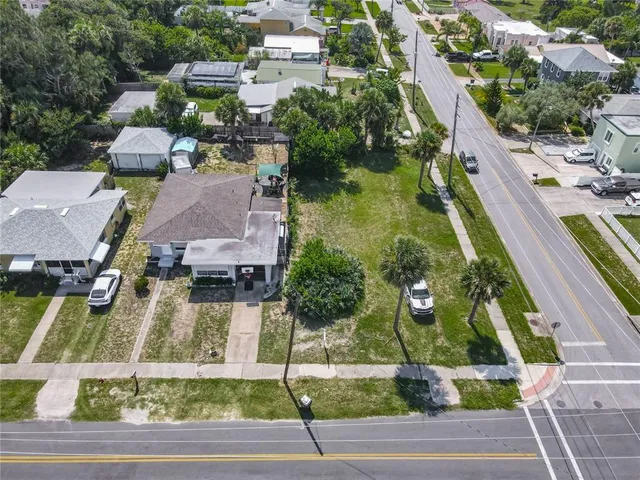 a view of a backyard with table and chairs