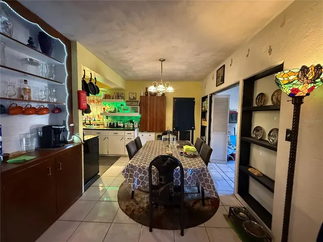 a living room with furniture a chandelier and a fireplace
