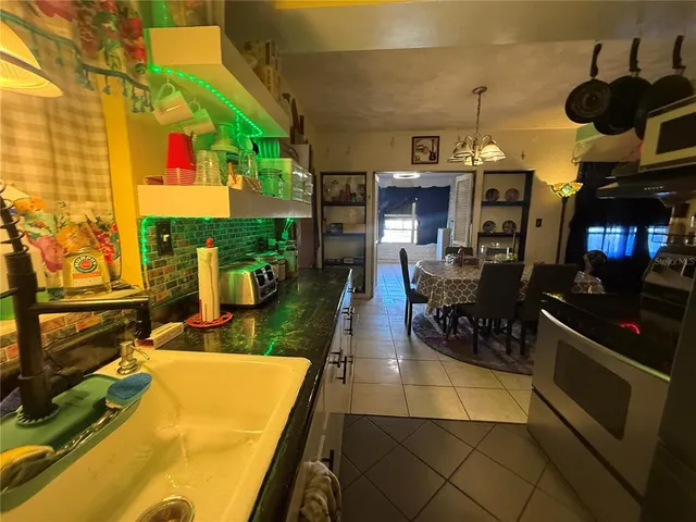 a view of a patio with dining table and chairs with wooden floor