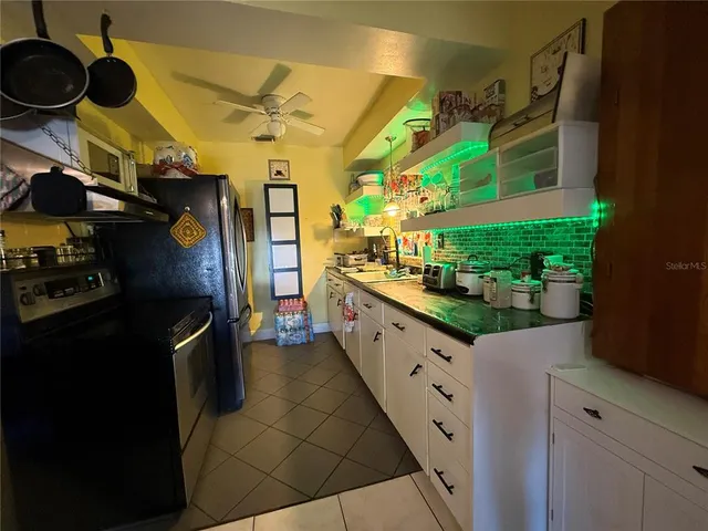 a kitchen with stainless steel appliances granite countertop a refrigerator and a stove