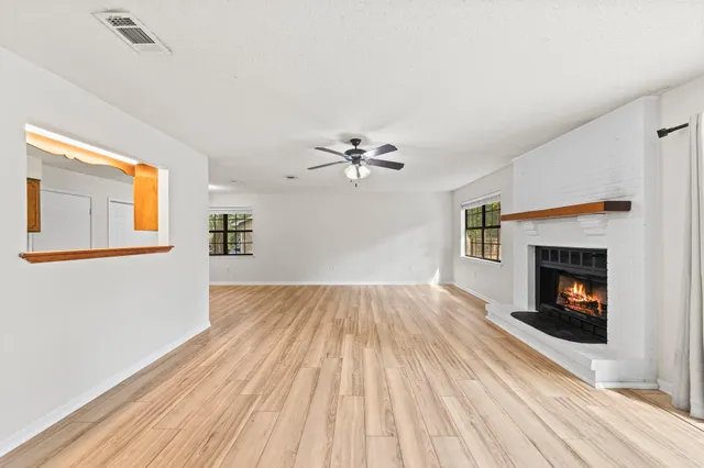 a view of main area fire place window and wooden floor