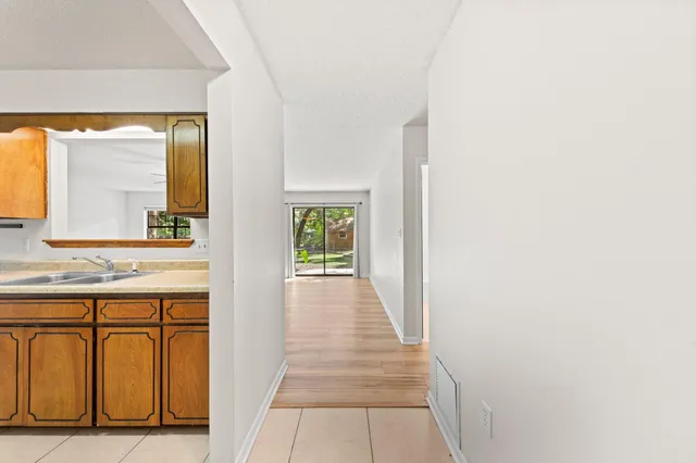 a hallway with a sink and a window