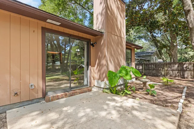 a backyard of a house with a fountain and plants