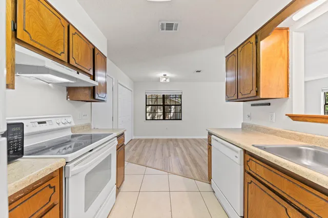 a utility room with cabinets washer and dryer