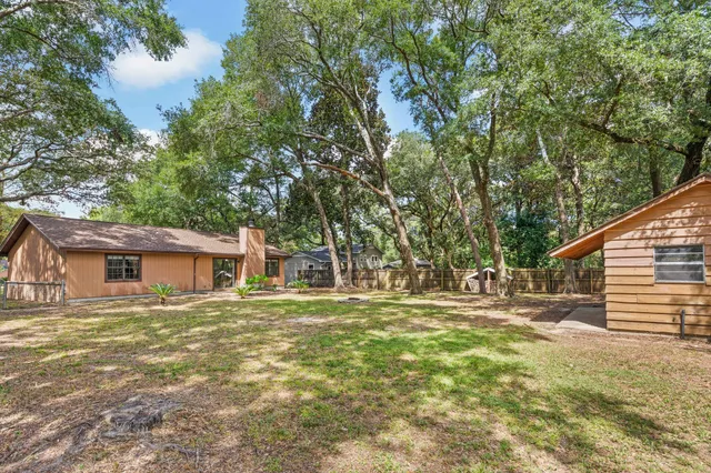 a backyard of a house with table and chairs