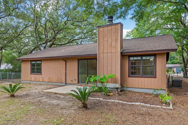 a front view of a house with a yard and potted plants