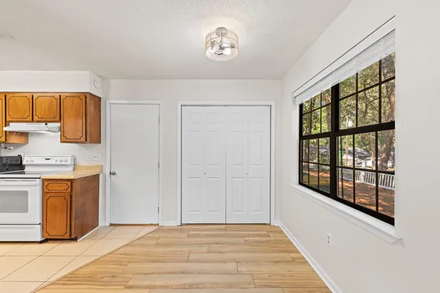 a view of a kitchen with wooden floor and electronic appliances