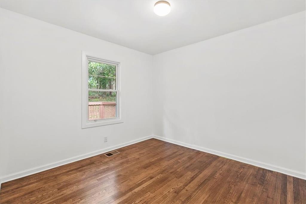 3406 Jackson Drive Decatur, GA 30032 - Photo 15 of 28 an empty room with wooden floor and windows