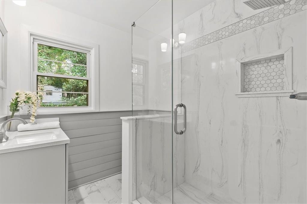 3406 Jackson Drive Decatur, GA 30032 - Photo 16 of 28 a bathroom with a sink a mirror and a shower