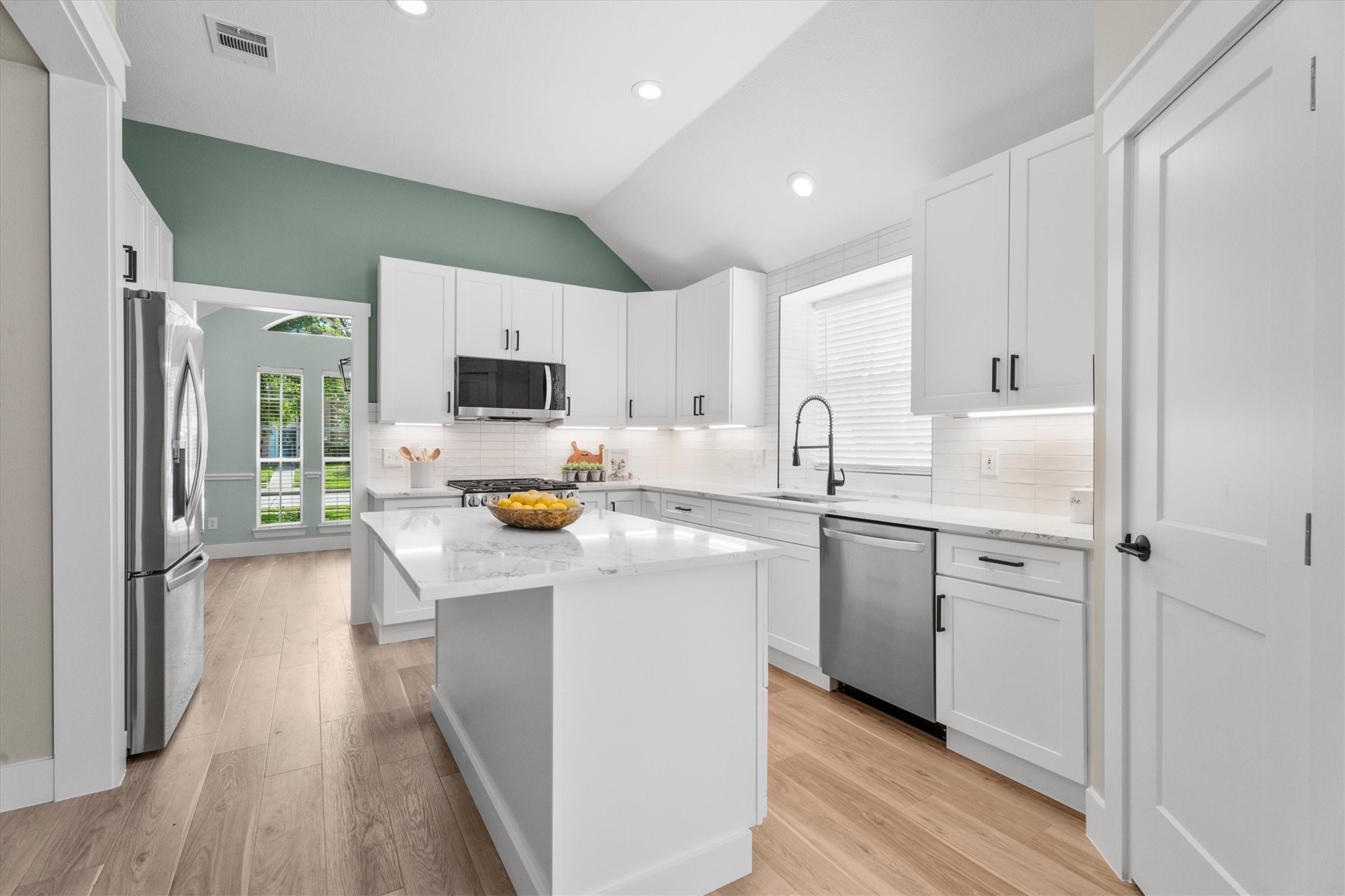 30111 Granum Drive Spring, TX 77386 - Photo 17 of 45 a kitchen with white cabinets and stainless steel appliances