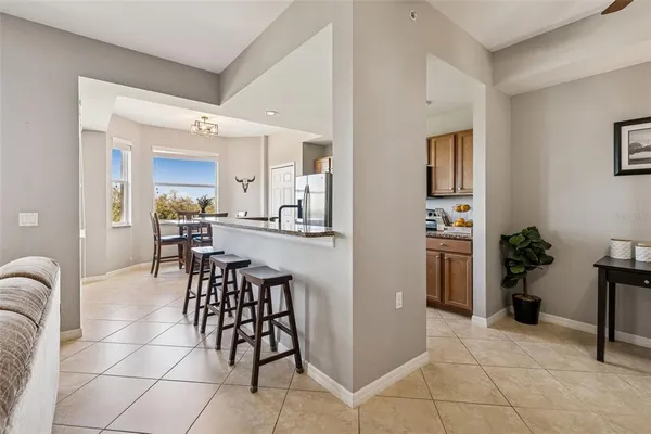 a living room with furniture a flat screen tv and a large window