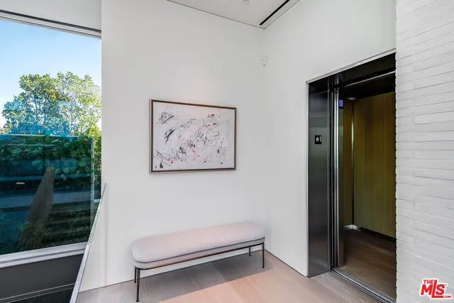 a living room with a bed and a painting on the wall
