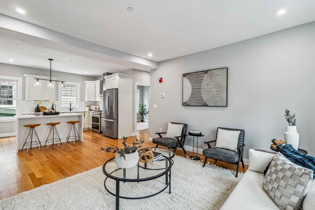 16 Alston Street, Unit 16 Somerville, MA 02143 - Photo 14 of 39 a living room with furniture and kitchen view