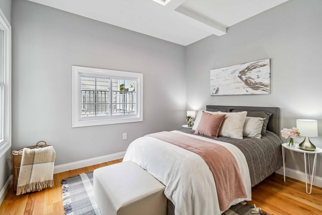 16 Alston Street, Unit 16 Somerville, MA 02143 - Photo 18 of 39 a bedroom with a bed and wooden floor