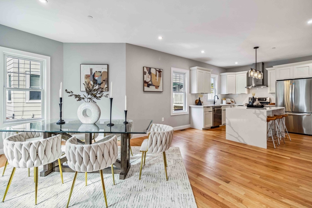 16 Alston Street, Unit 16 Somerville, MA 02143 - Photo 2 of 39 a living room with stainless steel appliances kitchen island granite countertop furniture and a wooden floor