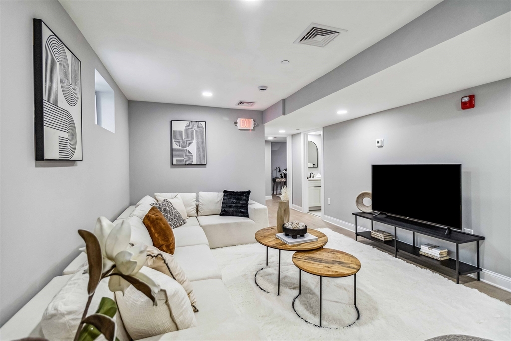 16 Alston Street, Unit 16 Somerville, MA 02143 - Photo 22 of 39 a living room with furniture and a flat screen tv