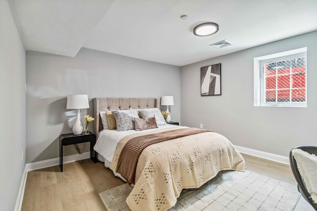 16 Alston Street, Unit 16 Somerville, MA 02143 - Photo 25 of 39 a bedroom with a bed and a painting on the wall