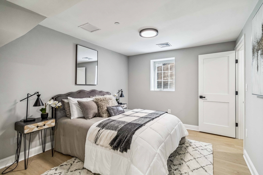 16 Alston Street, Unit 16 Somerville, MA 02143 - Photo 27 of 39 a bedroom with a large bed and a window
