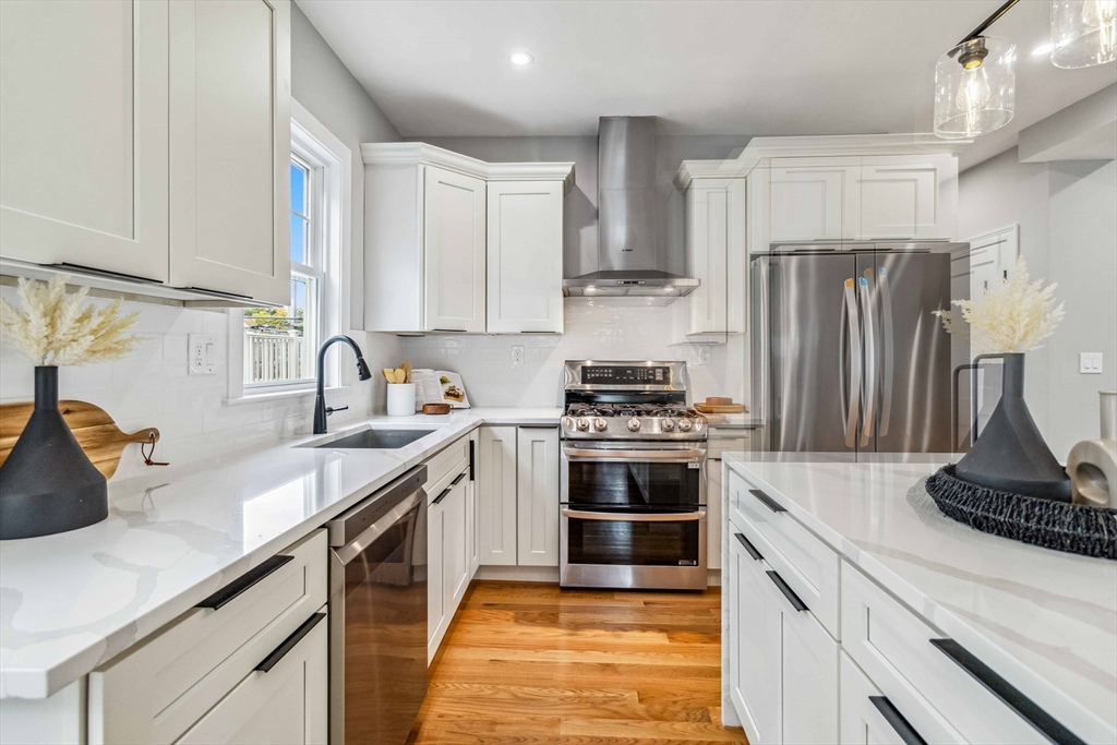 16 Alston Street, Unit 16 Somerville, MA 02143 - Photo 5 of 39 a kitchen with stainless steel appliances granite countertop a sink stove and refrigerator