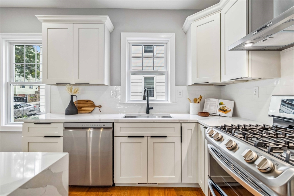 16 Alston Street, Unit 16 Somerville, MA 02143 - Photo 7 of 39 a kitchen with cabinets appliances and a window