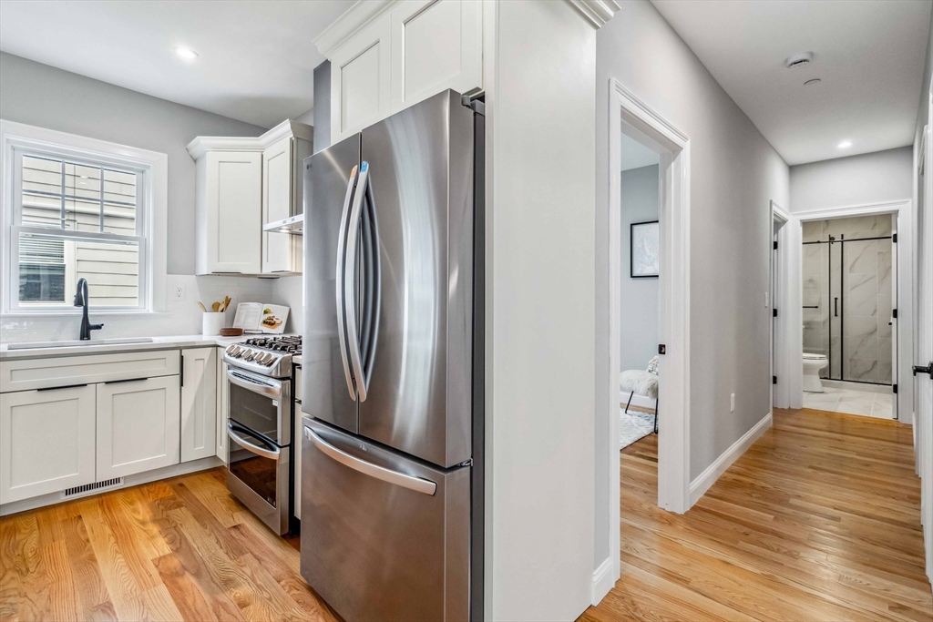 16 Alston Street, Unit 16 Somerville, MA 02143 - Photo 8 of 39 a kitchen with stainless steel appliances a refrigerator sink and microwave