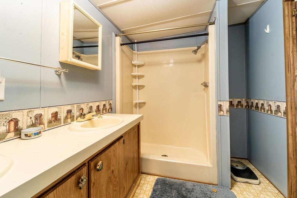 24031 Armadillo Road Astor, FL 32102 - Photo 23 of 43 a bathroom with a sink and a mirror