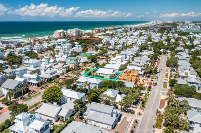 an aerial view of a house with a lot of trees all around