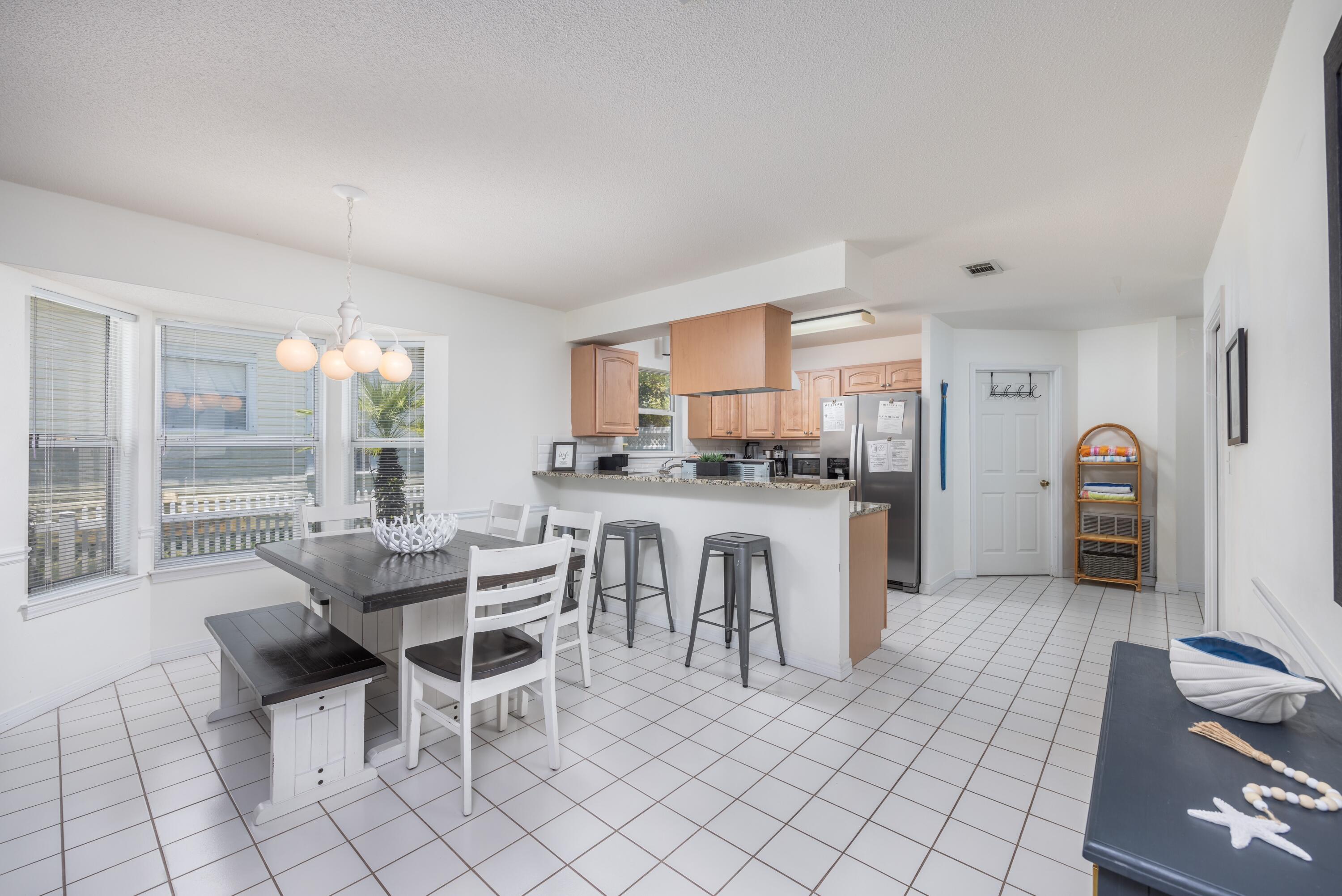 4450 Ocean View Drive Destin, FL 32541 - Photo 17 of 34 a kitchen with kitchen island granite countertop lots of white cabinets and stainless steel appliances