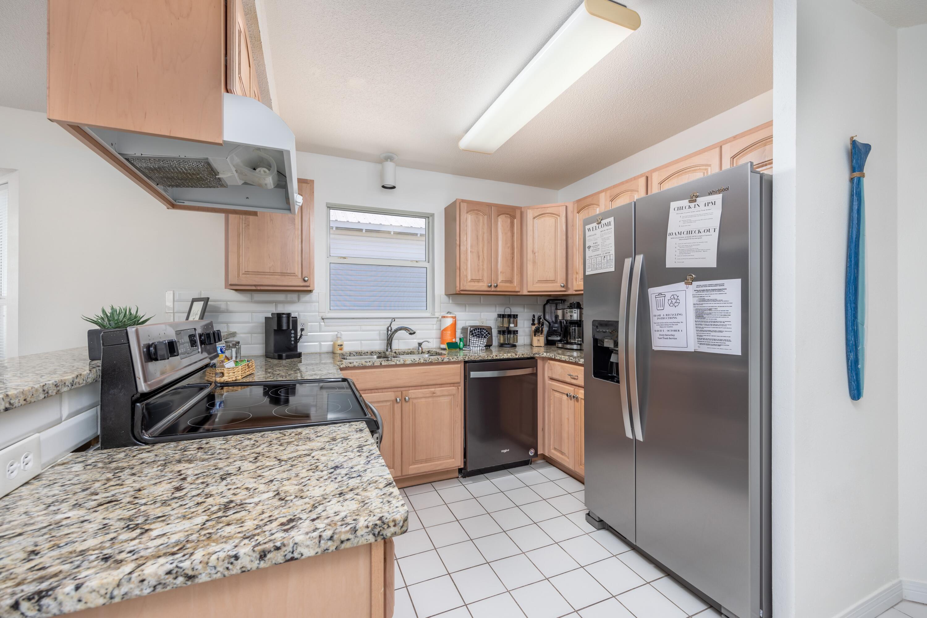 4450 Ocean View Drive Destin, FL 32541 - Photo 22 of 34 a kitchen with stainless steel appliances granite countertop a refrigerator stove and sink