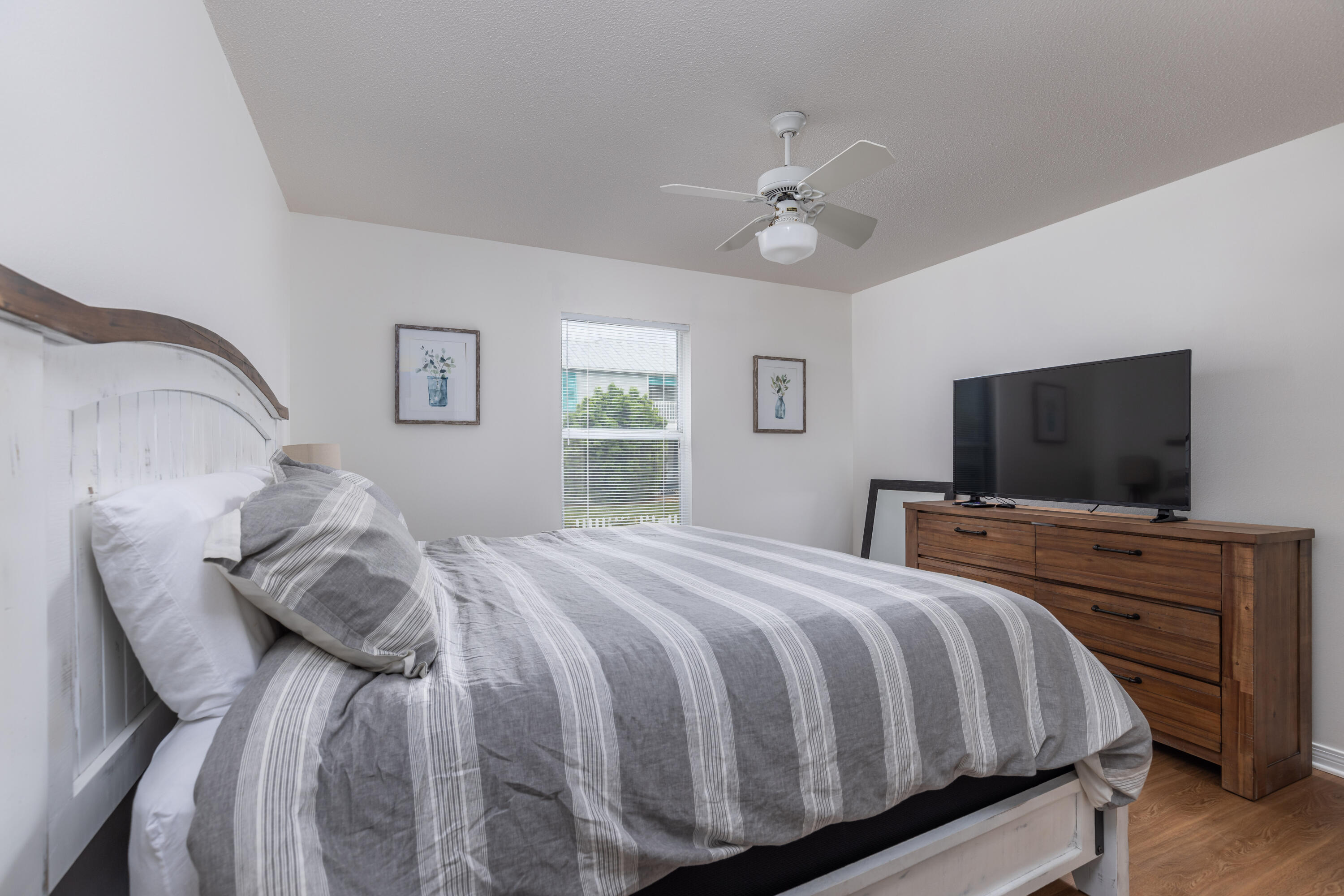 4450 Ocean View Drive Destin, FL 32541 - Photo 26 of 34 a bedroom with a bed and a flat screen tv