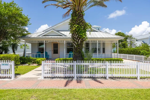 a front view of a house with a garden and deck