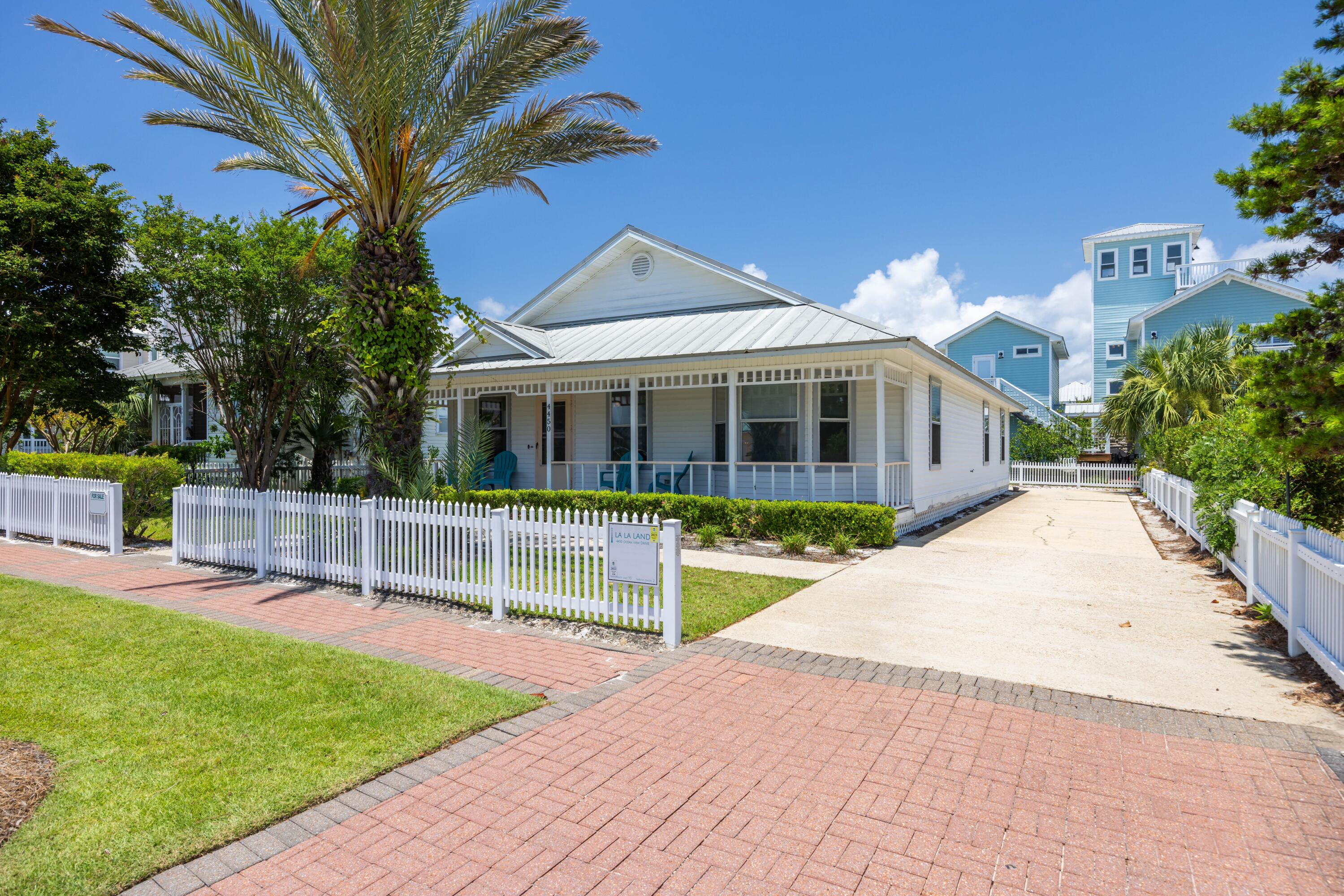 4450 Ocean View Drive Destin, FL 32541 - Photo 7 of 34 a front view of a house with a garden and plants