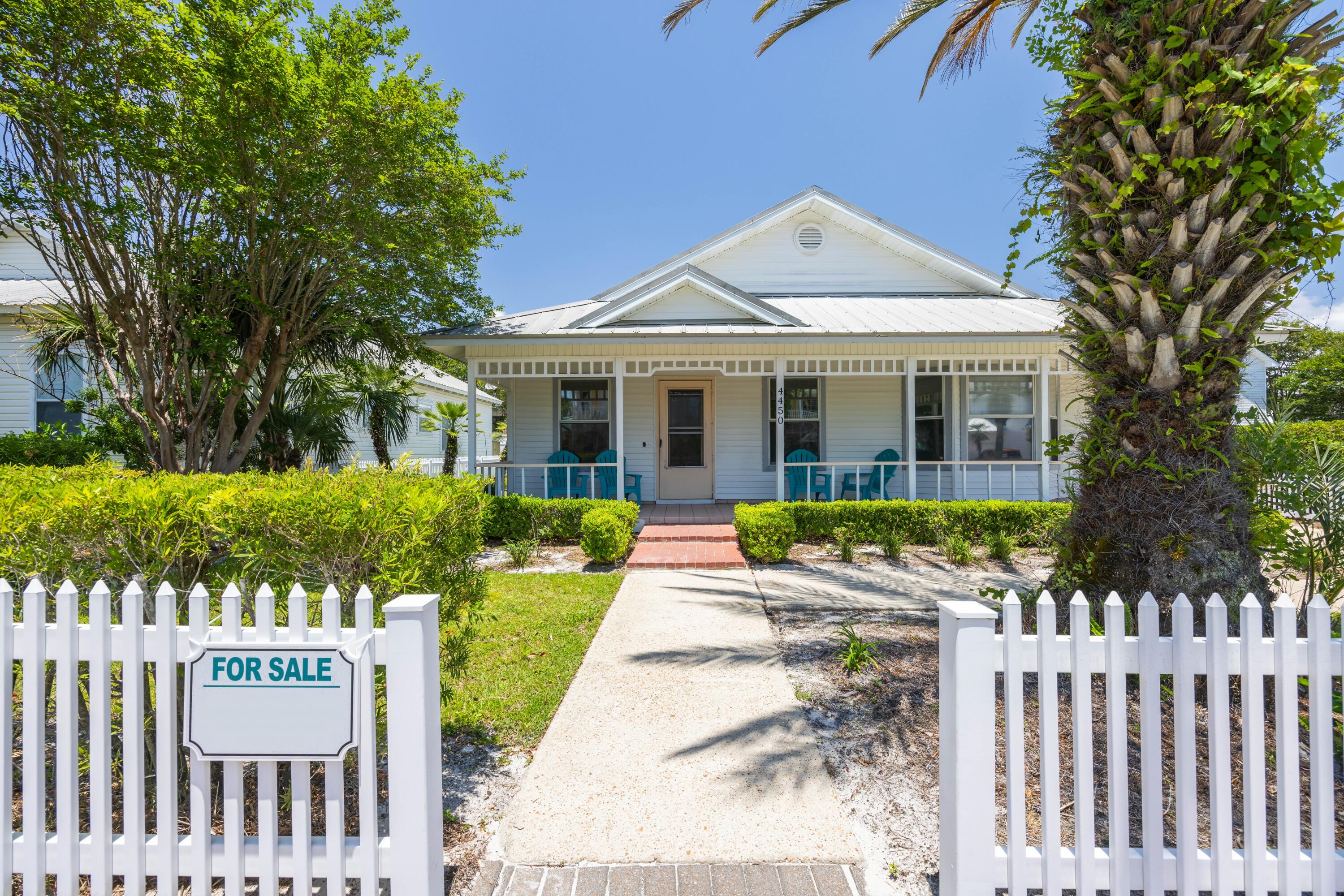 4450 Ocean View Drive Destin, FL 32541 - Photo 8 of 34 a front view of a house with a yard table and chairs