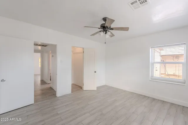 a view of room with window and wooden floor