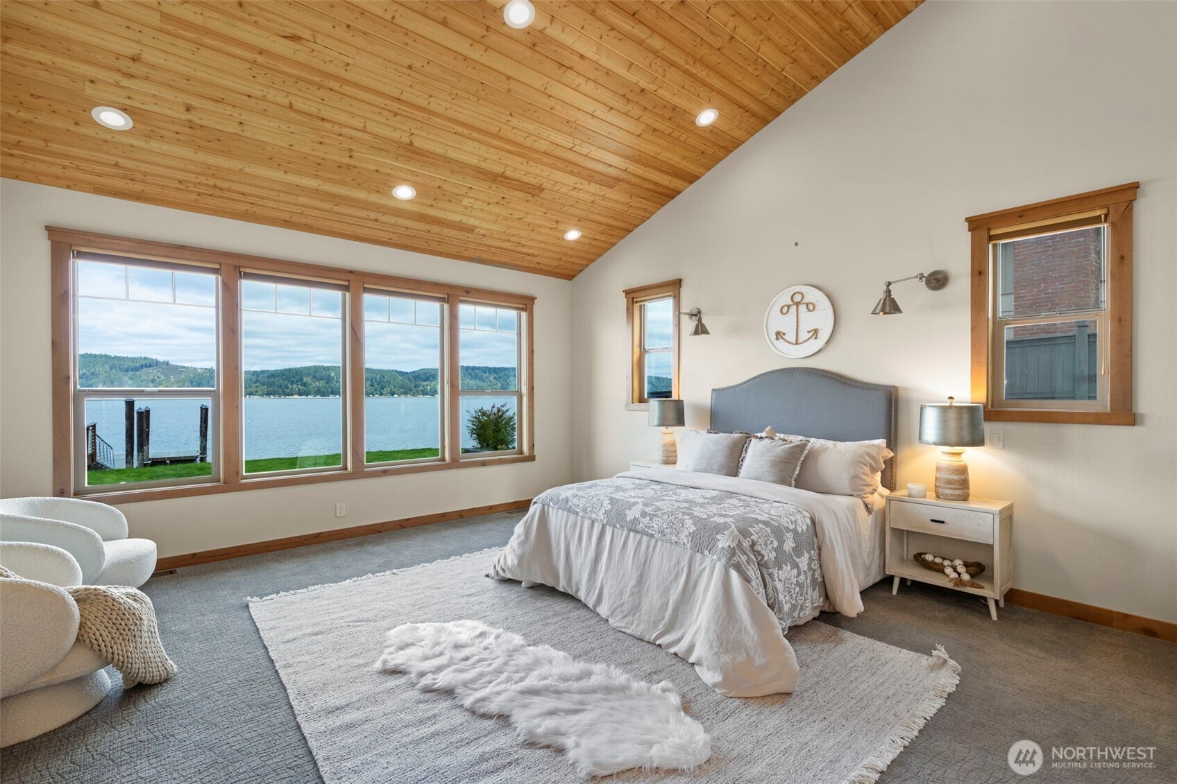 14341 Highway 106 Belfair, WA 98528 - Photo 13 of 40 a spacious bedroom with a large bed and a large window
