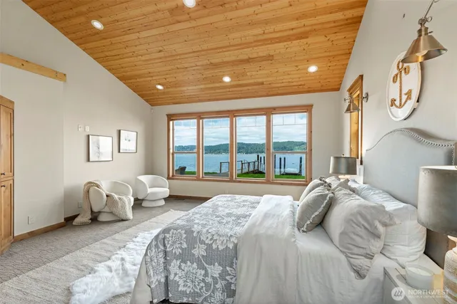 a living room with furniture a large window and a table