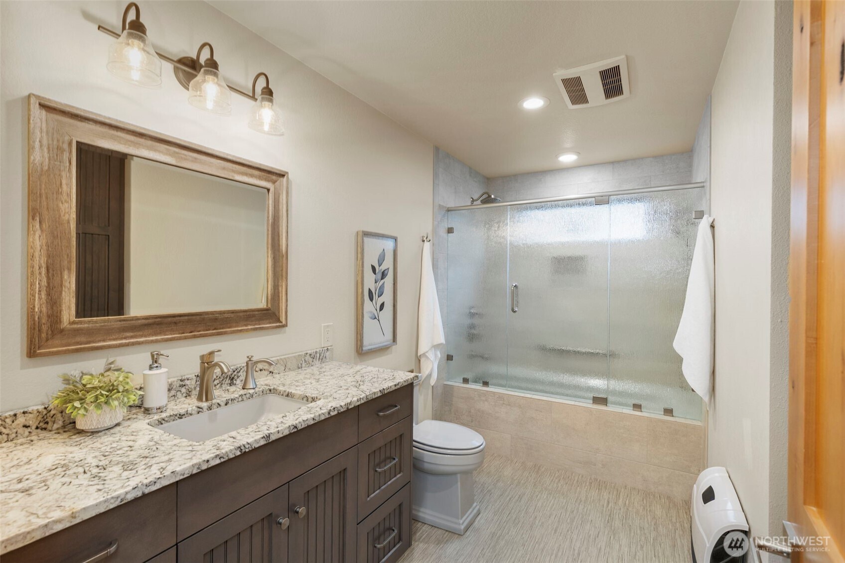 14341 Highway 106 Belfair, WA 98528 - Photo 20 of 40 a bathroom with a granite countertop sink toilet mirror and shower
