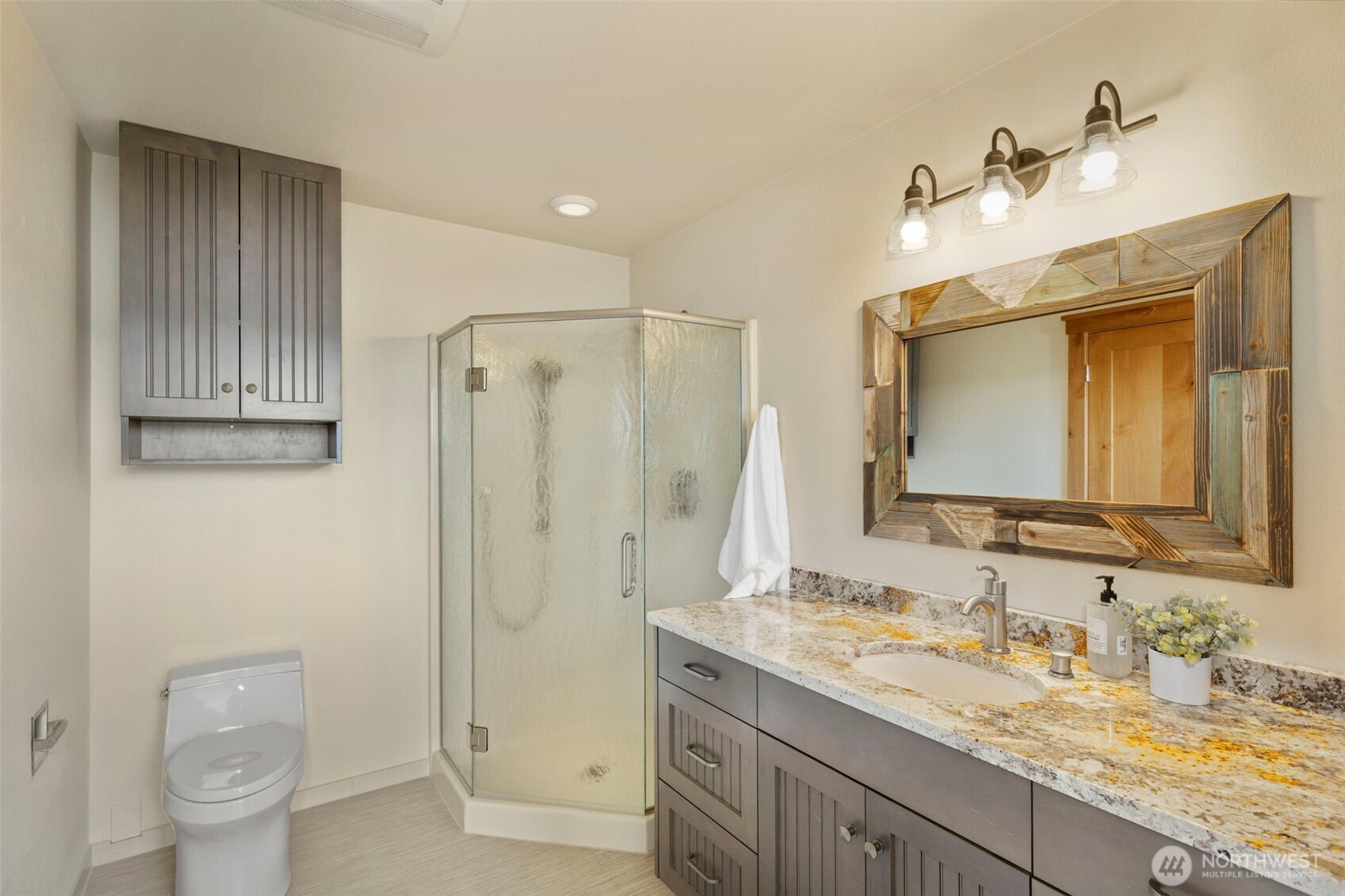 14341 Highway 106 Belfair, WA 98528 - Photo 21 of 40 a bathroom with a granite countertop sink toilet and shower