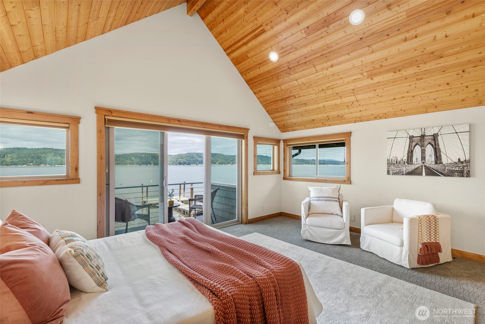 14341 Highway 106 Belfair, WA 98528 - Photo 28 of 40 a bedroom with a large bed and a large window