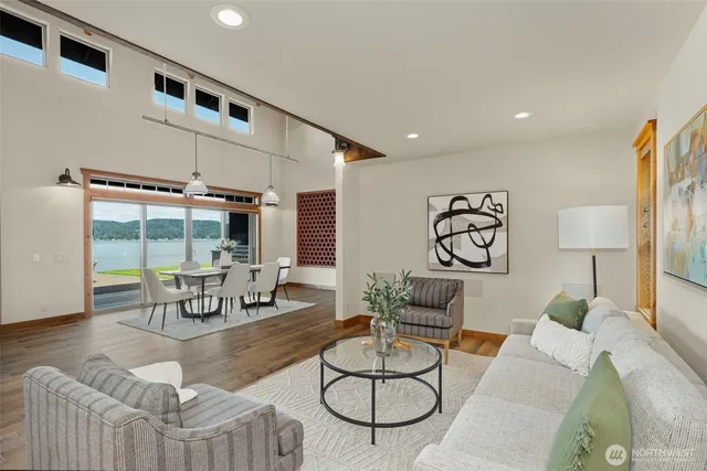 a dining hall with stainless steel appliances kitchen island granite countertop furniture and a kitchen view