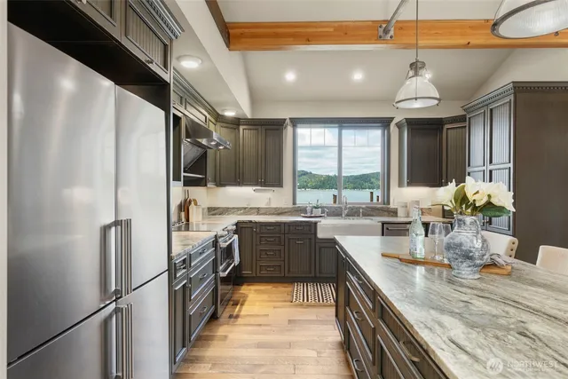 a kitchen with a stove and chairs