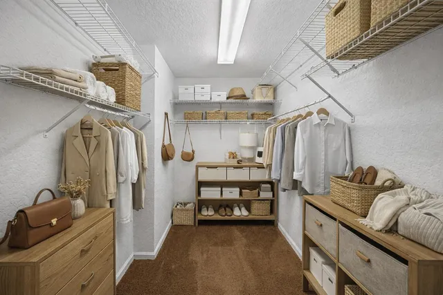 a view of a room with a ceiling fan and a window