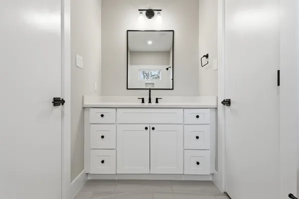 a large kitchen with stainless steel appliances kitchen island a sink dishwasher a refrigerator and a fireplace with wooden floor